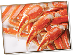 Picture of cooked snow crab legs with three claws over them